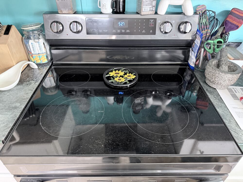 The same glass stovetop spotless and streak-free after cleaning.